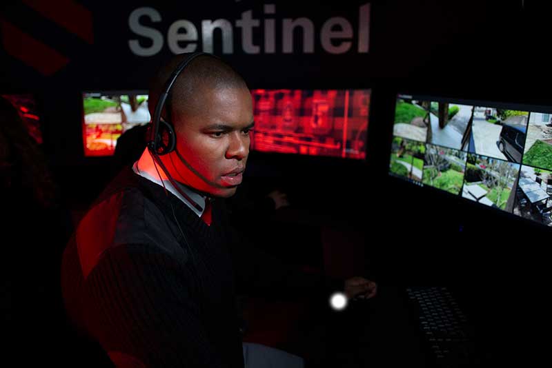 Deep Sentinel guard reviewing camera feeds at a monitoring station